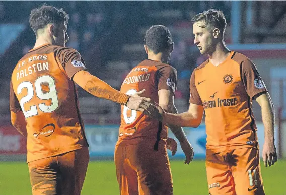  ??  ?? Anthony Ralston congratula­tes Billy King on his goal in Dundee United’s 5-0 win over Brechin last night that edges them closer to the play-offs.