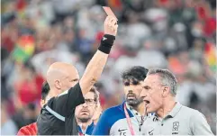  ?? AFP ?? South Korea coach Paulo Bento, right, is shown a red card by referee Anthony Taylor after his team’s match against Ghana.