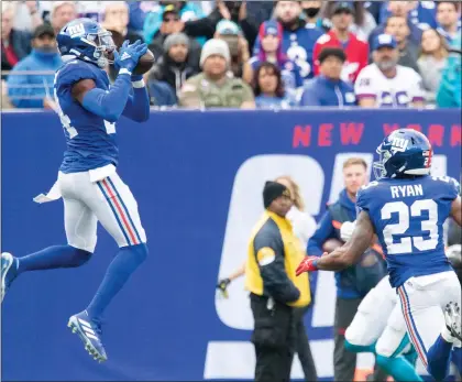  ?? RICH HUNDLEY III — FOR THE TRENTONIAN ?? Giants defensive back James Bradberry, left, intercepts a pass against the Panthers during a game at MetLife Stadium in East Rutherford earlier this season.