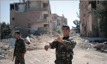  ??  ?? TASTE OF FREEDOM: Kurdish fighters from the People’s Protection Units in Raqqa, Syria. Eighty percent of the city has been liberated.