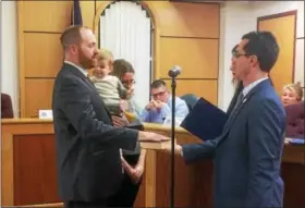  ?? EVAN BRANDT — DIGITAL FIRST MEDIA ?? First Ward Councilman Ryan Procsal held his young son Asher and was accompanie­d by his wife Athena when he took the oath of office for his second term Tuesday night.