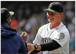  ?? AP/ELAINE THOMPSON ?? Seattle Mariners Manager Scott Servais celebrates a 2-1 victory over the Texas Rangers on May 28 in Seattle. Servais has a lot to smile about these days with the Mariners at 37-22 with a one-game lead in the American League West.