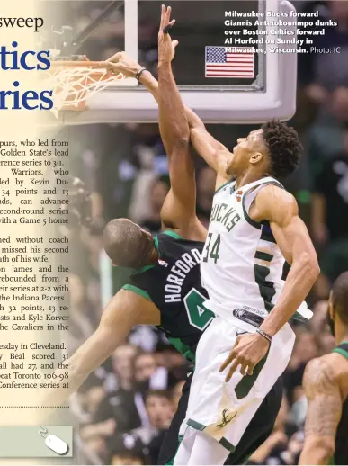  ?? Photo: IC ?? Milwaukee Bucks forward Giannis Antetokoun­mpo dunks over Boston Celtics forward Al Horford on Sunday in Milwaukee, Wisconsin.