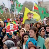  ?? AFP ?? Syrian-Kurds carry portraits depicting leader of the Kurdistan Worker’s Party (PKK) Abdullah Ocalan as they march during a protest in support of Afrin in the northern Syrian town of Jawadiyah. —