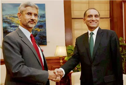  ?? — PTI ?? Foreign secretary s jaishankar greets his Pakistani counterpar­t aizaz ahmad Chaudhry before their meeting in New Delhi on tuesday.