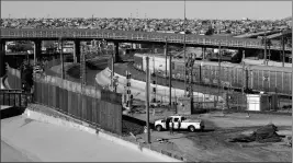  ?? ASSOCIATED PRESS ?? IN THIS JAN. 22 FILE PHOTO, A NEW BARRIER is built along the Texas-Mexico border near downtown El Paso. Such barriers have been a part of El Paso for decades and are currently being expanded, even as the fight over President Donald Trump’s desire to wall off the entire U.S.Mexico border.