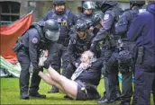  ?? Jessica Griffin Philadelph­ia Inquirer ?? POLICE OFFICERS remove a protester from the University of Pennsylvan­ia in Philadelph­ia on Friday.
