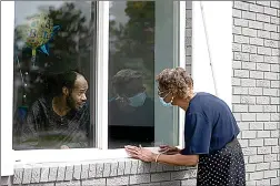  ??  ?? Southern Pines nursing home resident Wayne Swint gets a birthday visit from his mother, Clemittee Swint, on June 26, 2020, in Warner Robins, Ga. (AP Photo/John Bazemore, File)