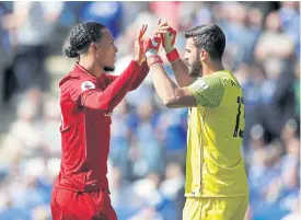  ??  ?? Liverpool defender Virgil van Dijk, left, and goalkeeper Alisson.