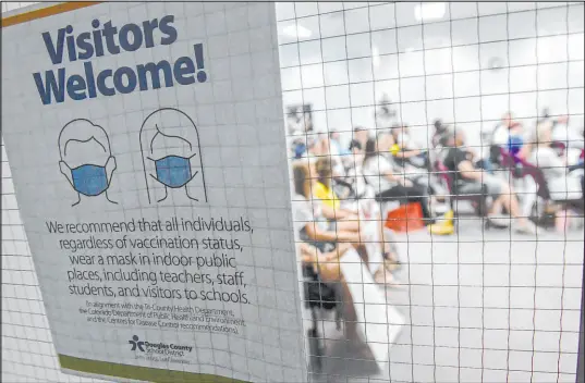  ?? Aaron Orntiveroz The Associated Press ?? A sign at the entrance to meeting chambers asks people to wear masks during an August Board of Education meeting in Castle Rock, Colorado, to discuss the use of masks in Douglas County Schools.