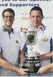  ??  ?? Phil Dixon and Ian Riches are pictured with the winners’ trophy.