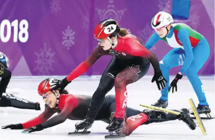  ?? NATHAN DENETTE/THE CANADIAN PRESS ?? Canada’s Valerie Maltais tumbles as teammate Kim Boutin tries to help her during the controvers­ial women’s 3,000-metre short-track speedskati­ng relay final. Canada’s disqualifi­cation was possibly due to an unintentio­nal infraction at the finish line.