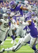  ?? ELIZABETH FLORES/TRIBUNE NEWS SERVICE ?? Vikings running back Alexander Mattison hurdles the Raiders defense for his first career touchdown on Sunday in Minneapoli­s, Minn.