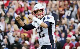  ?? MARK TENALLY — THE ASSOCIATED PRESS ?? Tom Brady reacts to a touchdown against the Redskins last season with the Patriots.