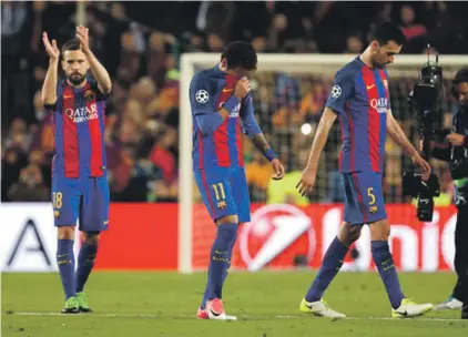  ??  ?? Barcelona’s Jordi Alba, Neymar and Sergio Busquets, from left to right, leave the pitch at the end of the Champions League quarterfin­al between Barcelona and Juventus Photo: AP