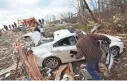  ?? CHRISTIAN GOODEN/ST. LOUIS POST-DISPATCH VIA AP ?? Randy Preston gathers valuables out of a car Wednesday in Perryville, Mo., a day after a tornado devastated the town.