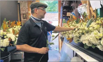  ?? COURTESY PHOTO ?? Michael Lanni, of Volanni Floral Design inWashingt­on, D.C., who grewup in Sterling Heights, works on a floral display for Supreme Court Justice Ruth Bader Ginsburg’s memorial, an honor and incredible experience he finds hard to describe.