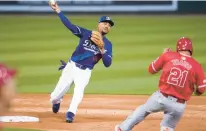  ?? ASHLEY LANDIS/AP ?? Dodgers second baseman Mookie Betts throws to first as the Angels’ Zach Neto grounds into a force out during the third inning of a spring training game in Phoenix on Tuesday.