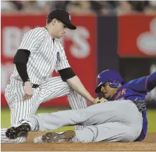  ?? AP PHOTO ?? NOT SO FAST: Yankees shortstop Tyler Wade tags out the Mets’ Juan Lagares, who was attempting to steal second base, last night in the Bronx.