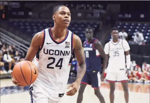  ?? Jessica Hill / Associated Press ?? UConn freshman Jordan Hawkins’ jersey matches the Huskies’ ranking in the preseason poll — No. 24.