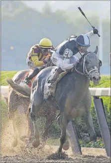  ?? [PETER MORGAN/THE ASSOCIATED PRESS] ?? Jose Ortiz raises his crop as he approaches the finish line aboard Tapwrit with runner-up Irish War Cry, ridden by Rajiv Maragh, close behind.