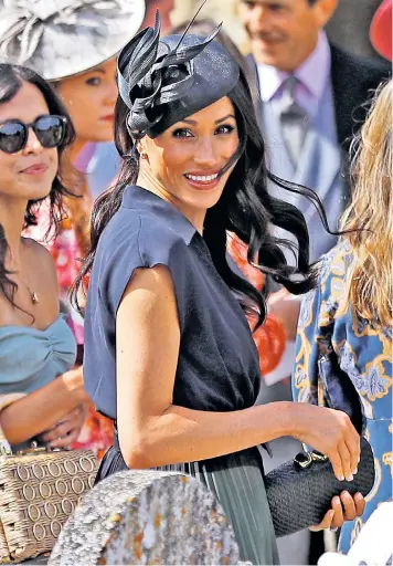  ??  ?? The Duchess of Sussex, who turned 37 yesterday, wore a navy blue Club Monaco shirt dress and fascinator for the wedding of Charlie van Straubenze­e, a close friend of her husband, and Daisy Jenks. The Duke was best man at the ceremony in Frensham, Surrey