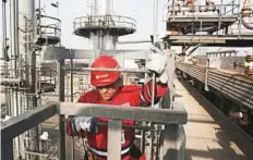  ?? Reuters ?? An oilfield worker at a facility in Anzoategui, Venezuela. Reimposed sanctions on Iran by the US and output declines from Venezuela may tighten the market further.