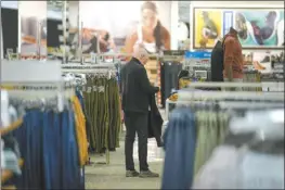  ?? AP file photo ?? A shopper looks at clothing displayed at a Kohl’s in Clifton, N.J., Jan. 26. On Tuesday, the Labor Department issues its report on inflation at the consumer level in February.