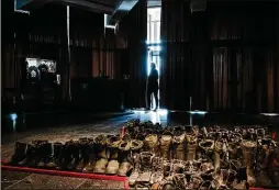  ?? NICOLE TUNG/THE NEW YORK TIMES ?? Boots left behind by Russian soldiers were arranged in the outline of a red star in the “Crucified Ukraine” show on May 21 at the National Museum of the History of Ukraine in the Second World War, in Kyiv, Ukraine.