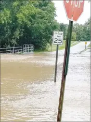  ?? COURTESY PHOTO ?? Hunter Street next to Creekside Park in Farmington was flooded Sunday morning, along with many other streets and county roads in western Washington County. According to the National Weather Service, Drake Field in Fayettevil­le registered 4.27 inches of rain during a 12-hour period beginning midnight Saturday.