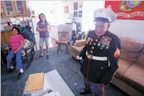  ?? LUIS SÁNCHEZ SATURNO/THE NEW MEXICAN ?? Tesuque resident Vicente Jimenez, 92, wears his dress Marine uniform at home Wednesday with his wife, Gloria Jimenez, left, and daughter, Bernice Jimenez.