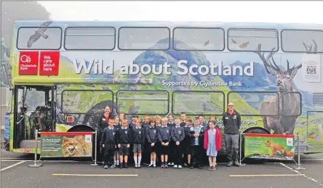  ?? 02_b41wild02 ?? Above: Education officers, Lindsay Selmes, and Jamie Ormiston, with Brodick primary pupils who wait excitedly to enter the bus