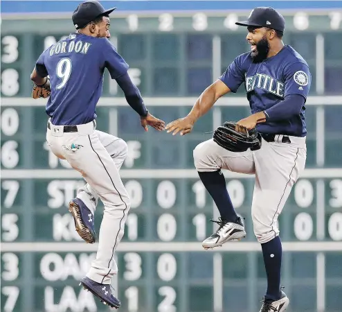  ?? — THE ASSOCIATED PRESS ?? Mariners’ Dee Gordon and Denard Span celebrate after sweeping the Astros Sunday.