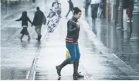  ?? (Hadas Parush/Flash 90) ?? A WOMAN walks in downtown Jerusalem in the rain on Wednesday.