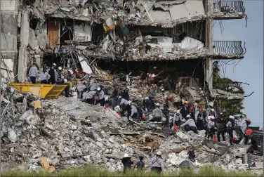  ?? (AP/Miami Herald/Al Diaz) ?? Rescuers work through the rubble Tuesday at the Champlain Towers South residentia­l condo in Surfside, Fla. State Attorney Katherine Fernandez Rundle said Tuesday that she will pursue a grand jury investigat­ion to examine factors and decisions that led to the collapse.