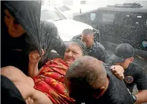  ?? PHOTO: REUTERS ?? Rescue workers carry a woman into the Emergency Operation Centre after the the area was hit by Hurricane Maria in Guayama, Puerto Rico.