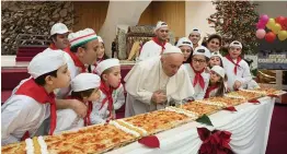  ?? — AP ?? Pope Francis blows a candle on the occasion of his 81st birthday during a private audience with children at the Vatican on Sunday. The Pope celebrated his birthday with a hero cake and a message urging the world — and children in particular — to join...