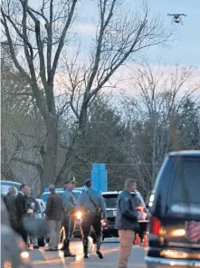  ?? CHRIS CHRISTO / BOSTON HERALD ?? LOOK, UP IN THE SKY: Police use a drone to search for a suspect in the stabbing of a state tooper in New Salem yesterday.