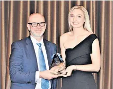  ?? ?? Coach of the Year Mhairi Lake of Biggar Netball Club collects her award from David Booth, SLC executive director of community and enterprise resources