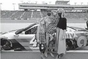  ?? PHOTO/RALPH FRESO] [AP ?? Jimmie Johnson, center, stands with his family on pit road prior to Sunday's NASCAR Cup Series race at Phoenix Raceway in Avondale, Ariz. The seven-time champion retired as a full-time driver after the race.