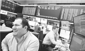  ?? — Reuters photo ?? A trader at the Frankfurt stock exchange reacts on morning trading results in Frankfurt, Germany, May 8. The euro topped US$1.10 for the first time in six months in early Asian trading yesterday, and riskier assets were expected to rally when other...