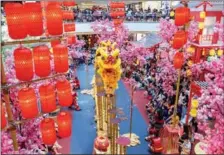  ?? CHONG VOON CHUNG / XINHUA ?? People gather to watch a high stake lion dance during a Chinese New Year celebratio­n in Kuala Lumpur, Malaysia, on Feb 5.