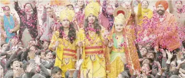  ?? NARINDER NANU/AGENCE FRANCE-PRESSE ?? SCHOOL students dress in the guise of Hindu deities Lord Ram (center), Laxman (left) and Sita (right) in Amritsar, India, ahead of the consecrati­on ceremony of Ayodhya’s Ram temple.