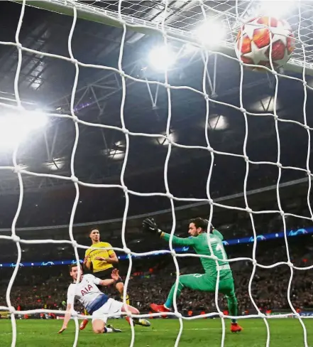  ?? — Reuters ?? Top of the net: Tottenham’s Jan Vertonghen (on ground) scoring against Borussia Dortmund in the first leg at Wembley on Feb 13. Spurs won 3-0.