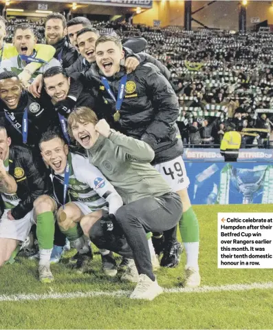  ??  ?? 2 Celtic celebrate at Hampden after their Betfred Cup win over Rangers earlier this month. It was their tenth domestic honour in a row.