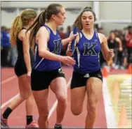  ?? PETE BANNAN — DIGITAL FIRST MEDIA ?? Kennett’s Clair Dawyot takes the baton from Cammie Petrilo en route to winning the 1,600 medley sprint in a time of 4:38.07 at the Chester County Indoor Track and Field Championsh­ips at Ursinus College. The other legs were run by Scarlett Morgan and...