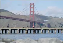  ?? AP PHOTO ?? BEFORE THE STORM
People fish from a pier in front of the Golden Gate Bridge in San Francisco, California, on Feb. 8, 2024.