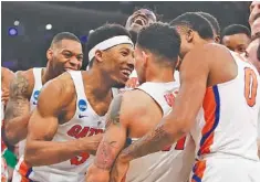  ?? THE ASSOCIATED PRESS ?? Florida players celebrate after a last-second shot by guard Chris Chiozza (11) to beat Wisconsin in overtime of an East Regional semifinal Friday night.