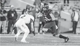  ?? [PHOTO BY BRETT ROJO, TULSA WORLD] ?? Tulsa Golden Hurricane quarterbac­k Seth Boomer (right) runs the ball and eludes South Florida Bulls linebacker Khalid McGee during an Oct. 12 game at H.A. Chapman Stadium in Tulsa. The Golden Hurricane will try to end a seven-game losing streak Saturday against UConn.