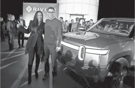  ?? SANDY HOOPER/USA TODAY ?? Rivian CEO RJ Scaringe and Rihanna are all smiles about the Rivian R1T, a fully electric pickup, as it made its debut in Los Angeles.